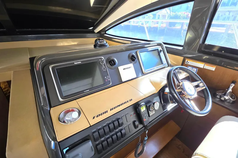  Yacht Photos Pics 2016 Sea Ray Sundancer 400 helm with navigation screens and steering wheel.