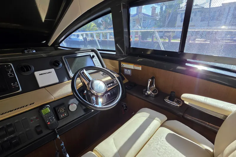  Yacht Photos Pics Interior cockpit of 2016 Sea Ray Sundancer 400 yacht with steering wheel and controls.