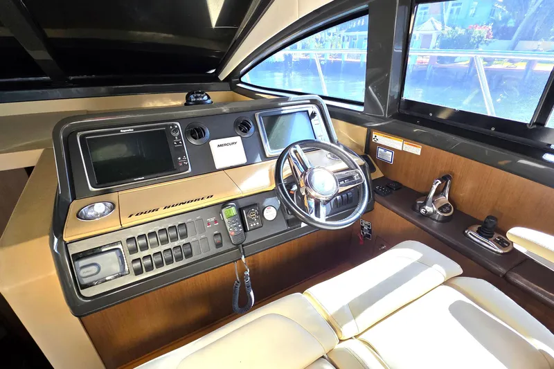  Yacht Photos Pics 2016 Sea Ray Sundancer 400 helm with modern navigation controls and luxurious seating.