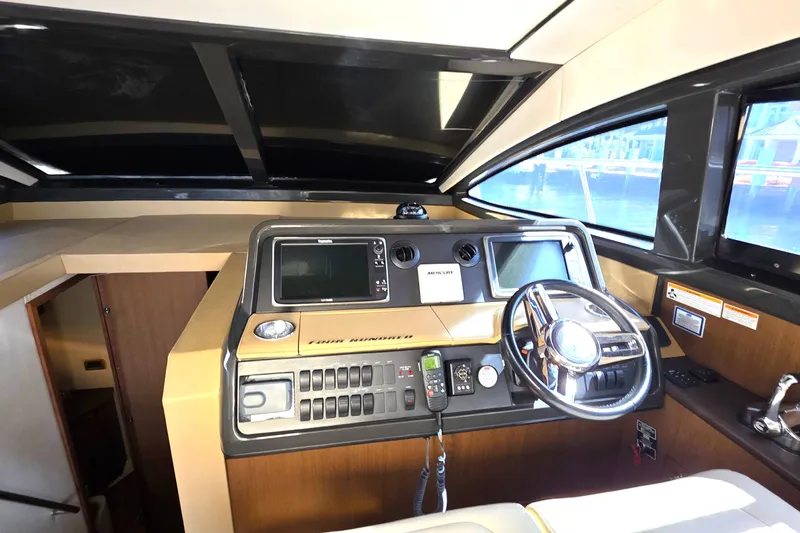  Yacht Photos Pics 2016 Sea Ray Sundancer 400 helm with modern navigation controls and steering wheel.