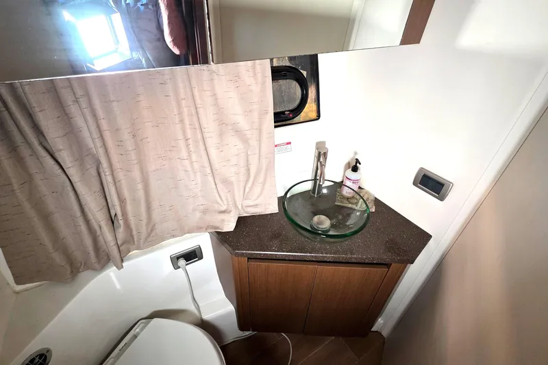  Yacht Photos Pics Bathroom interior of 2016 Sea Ray Sundancer 400 yacht with modern sink and fixtures.