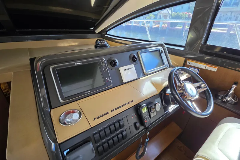  Yacht Photos Pics 2016 Sea Ray Sundancer 400 helm with navigation screens and steering wheel.