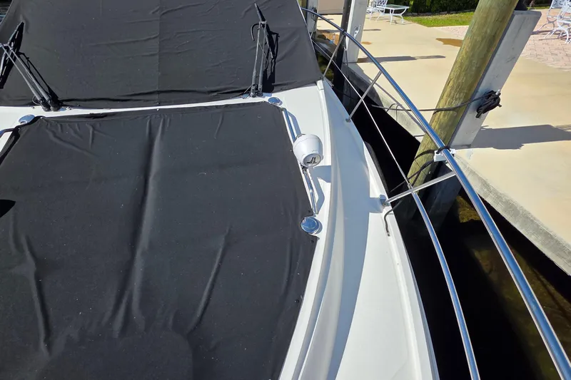  Yacht Photos Pics 2016 Sea Ray Sundancer 400 yacht with black cover docked at marina.