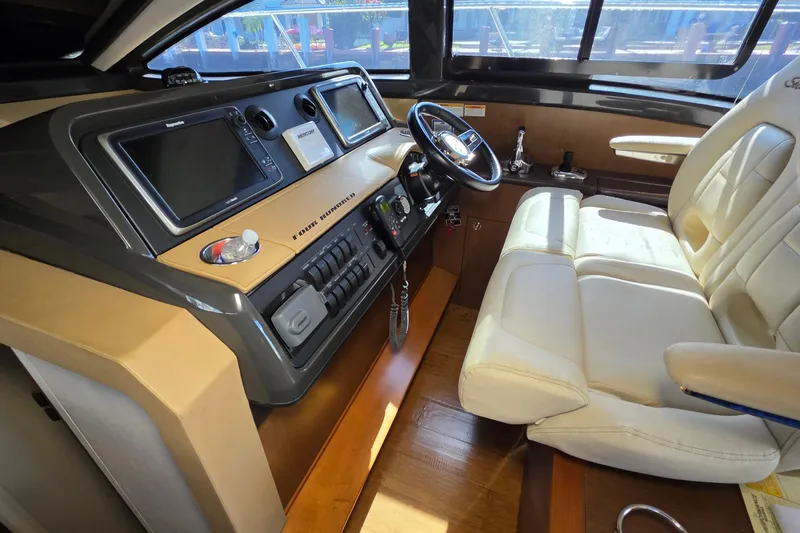  Yacht Photos Pics Interior cockpit of 2016 Sea Ray Sundancer 400 yacht with modern controls and leather seating.