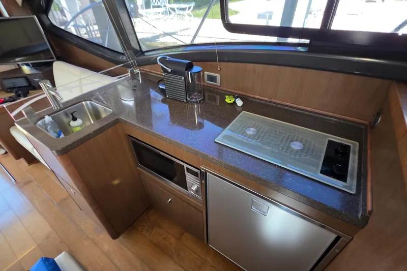  Yacht Photos Pics 2016 Sea Ray Sundancer 400 yacht kitchen with sink, stove, and appliances.