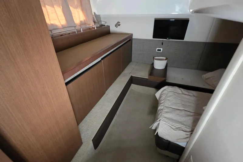  Yacht Photos Pics Interior cabin of 2016 Sea Ray Sundancer 400 yacht with bed and TV.