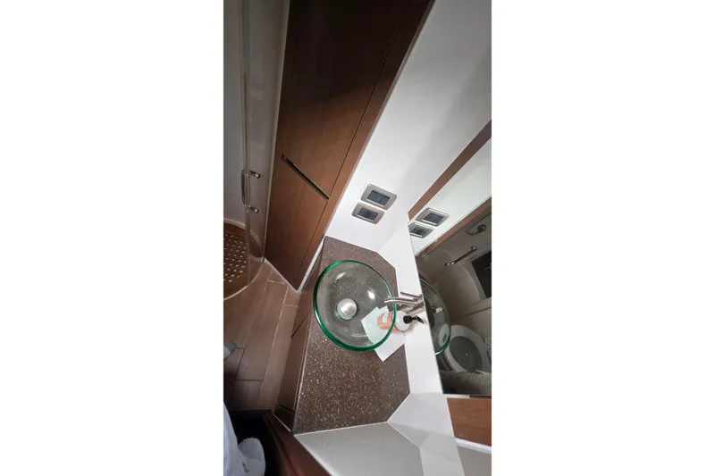  Yacht Photos Pics Bathroom interior of 2016 Sea Ray Sundancer 400 yacht with glass sink and modern fixtures.