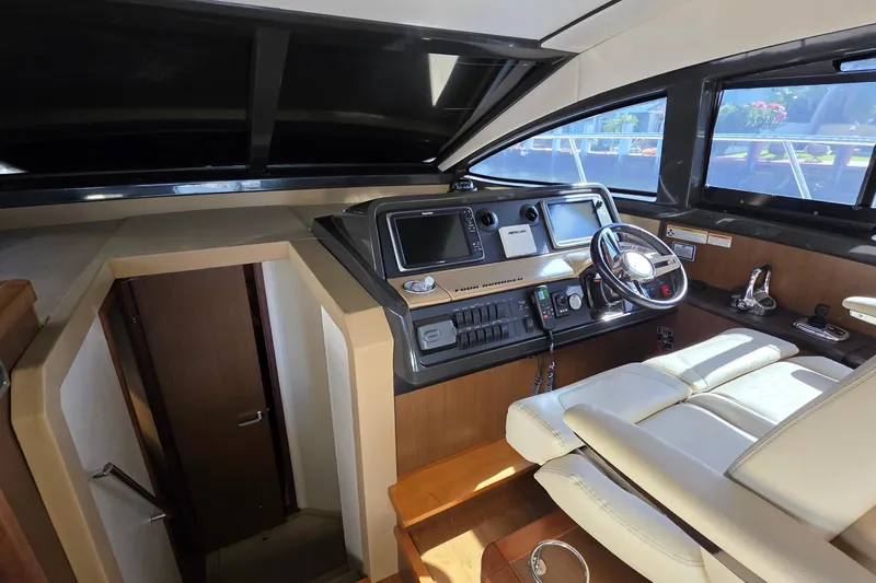  Yacht Photos Pics 2016 Sea Ray Sundancer 400 helm with modern controls and comfortable seating.