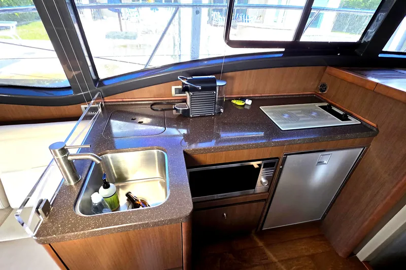  Yacht Photos Pics 2016 Sea Ray Sundancer 400 yacht kitchen with sink, stove, and appliances.