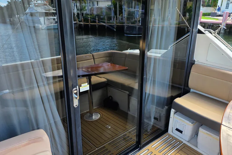  Yacht Photos Pics 2016 Sea Ray Sundancer 400 yacht interior with seating and table by the water.