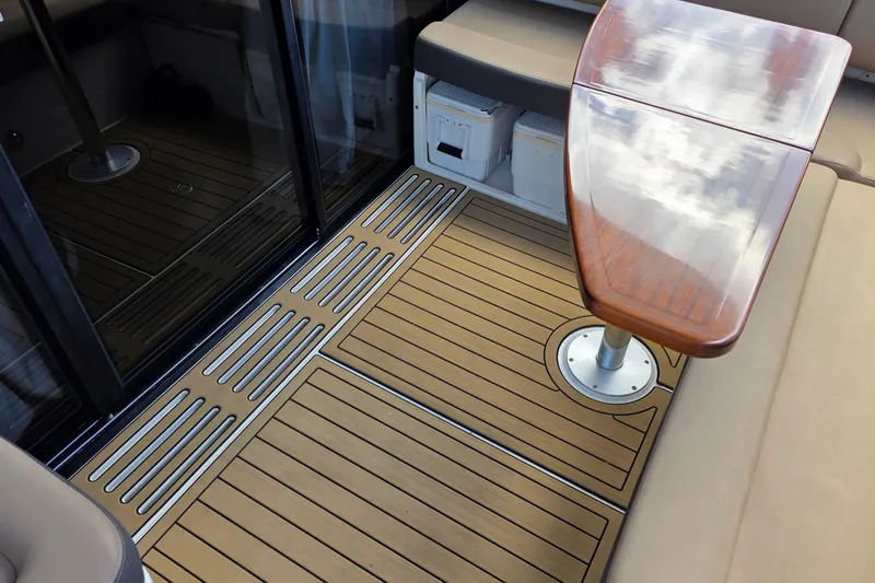  Yacht Photos Pics 2016 Sea Ray Sundancer 400 interior with wooden table and cushioned seating.