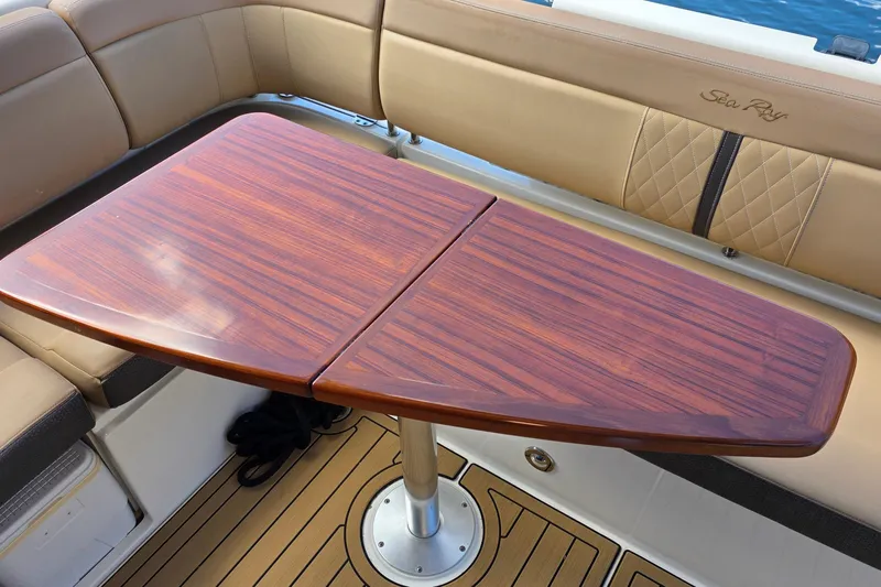  Yacht Photos Pics Luxurious interior of 2016 Sea Ray Sundancer 400 with elegant wooden table and seating.