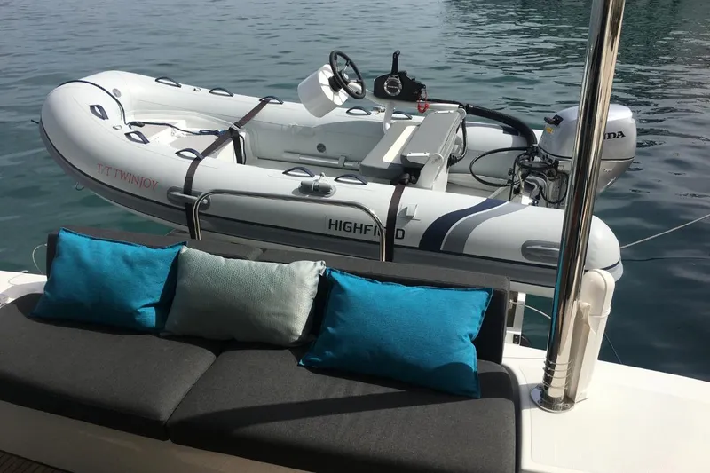 Twin Joy Yacht Photos Pics Inflatable boat on Lagoon 50 yacht, 2019 model, with blue cushions on deck.