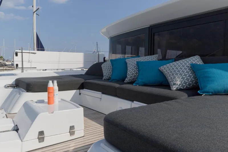 Twin Joy Yacht Photos Pics Luxurious 2019 Lagoon 50 yacht deck with comfortable seating and vibrant cushions.