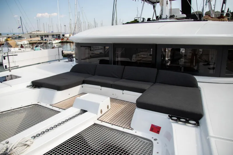 Twin Joy Yacht Photos Pics Luxurious 2019 Lagoon 50 catamaran with spacious deck seating in marina setting.