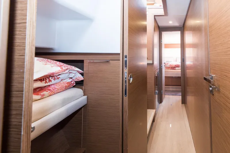 Twin Joy Yacht Photos Pics Interior of 2019 Lagoon 50 yacht, featuring cozy wooden cabin and bedding.