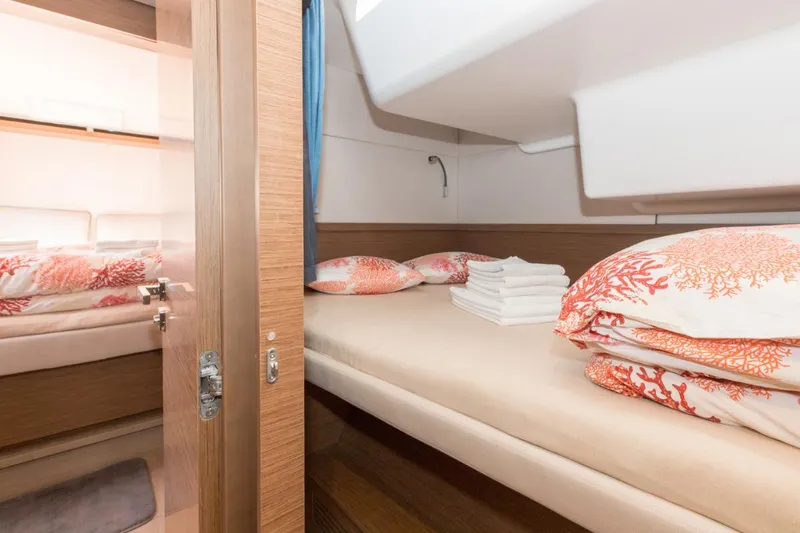 Twin Joy Yacht Photos Pics Luxurious cabin interior of 2019 Lagoon 50 yacht with coral-themed bedding.