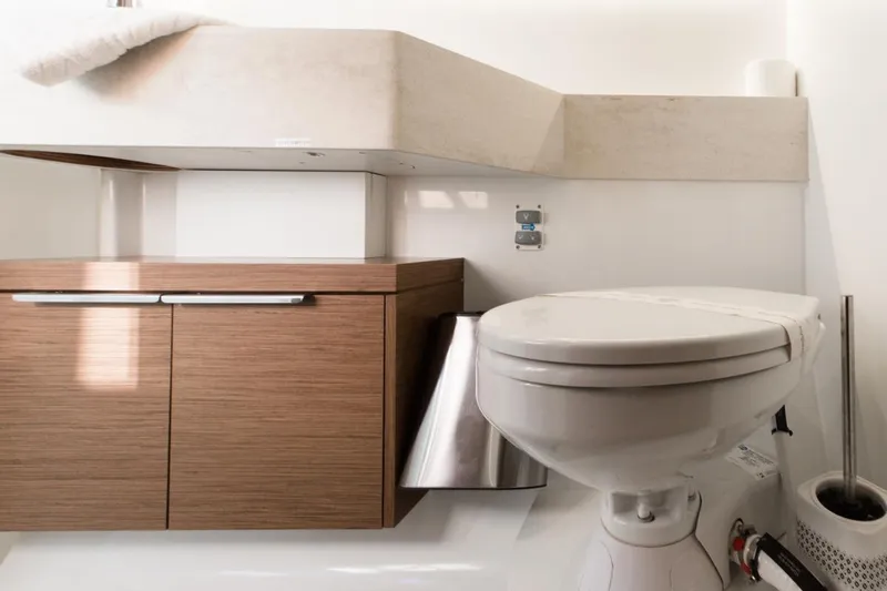 Twin Joy Yacht Photos Pics Modern bathroom in 2019 Lagoon 50 yacht with wooden cabinetry and white fixtures.