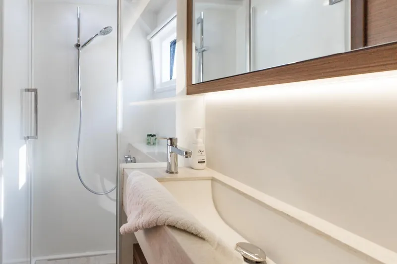 Twin Joy Yacht Photos Pics Modern bathroom interior on 2019 Lagoon 50 yacht, featuring sleek shower and vanity.
