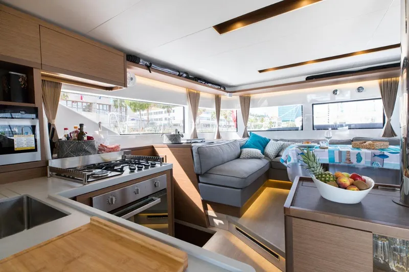 Twin Joy Yacht Photos Pics Luxurious interior of 2019 Lagoon 50 yacht with modern kitchen and cozy seating area.