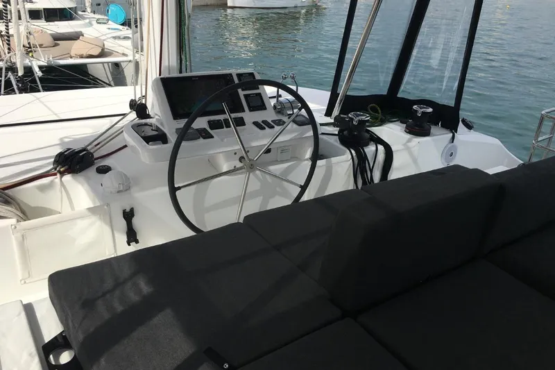 Twin Joy Yacht Photos Pics Cockpit of 2019 Lagoon 50 catamaran with steering wheel and navigation controls.