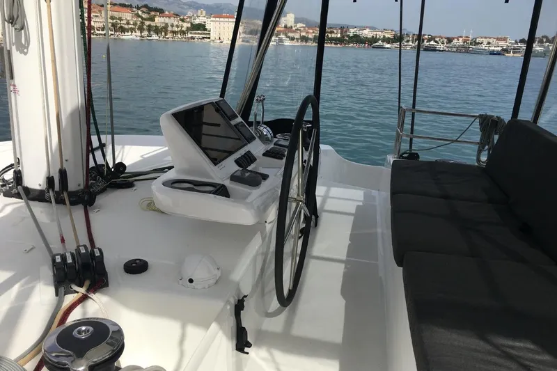 Twin Joy Yacht Photos Pics Cockpit of 2019 Lagoon 50 catamaran with steering wheel and navigation equipment.