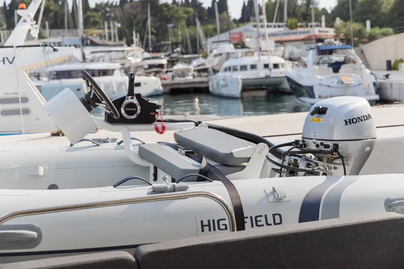 Twin Joy Yacht Photos Pics Highfield boat with Honda motor docked at marina, featuring Lagoon 50 model in background.
