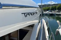 Fairline Targa 48 Open yacht, 2020 model, docked at a marina under a clear blue sky.