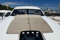 2020 Fairline Targa 48 Open yacht with sunbed, docked in marina under clear blue sky.