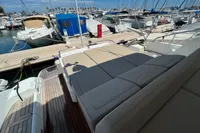 Fairline Targa 48 Open 2020 yacht with sunbed, docked at marina.
