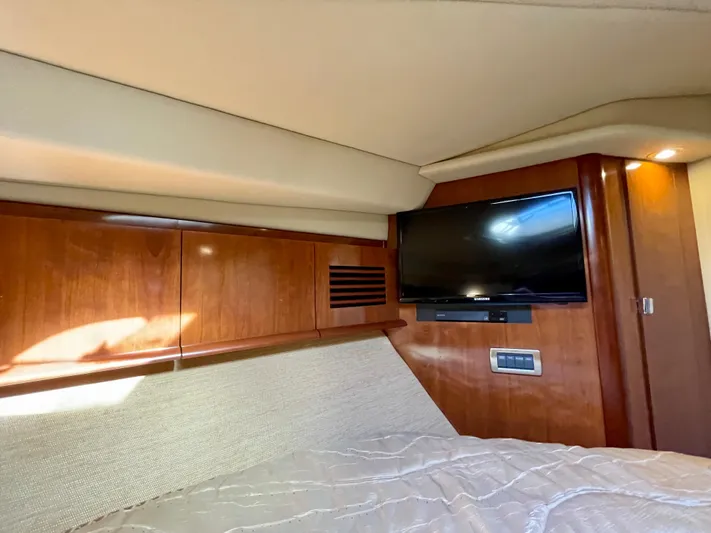Deja Blue Yacht Photos Pics Interior cabin of 2005 Sea Ray 390 Sundancer with TV and wooden paneling.