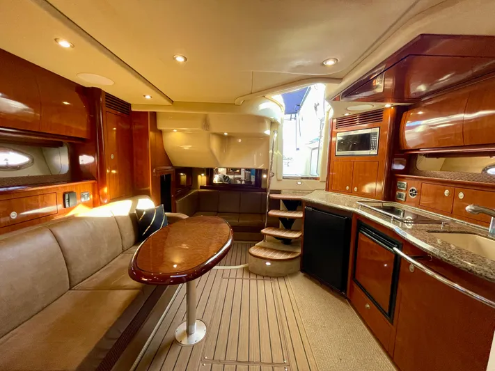 Deja Blue Yacht Photos Pics Luxurious interior of 2005 Sea Ray 390 Sundancer yacht with wood finishes and modern amenities.