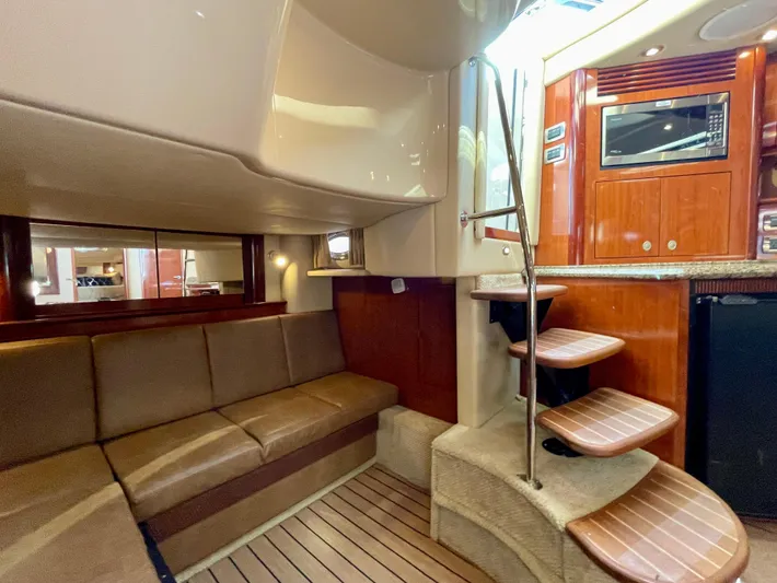 Deja Blue Yacht Photos Pics Interior of 2005 Sea Ray 390 Sundancer yacht with wooden cabinetry and seating area.