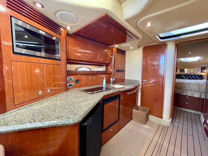 Deja Blue Yacht Photos Pics Luxurious interior of 2005 Sea Ray 390 Sundancer yacht with modern kitchen amenities.