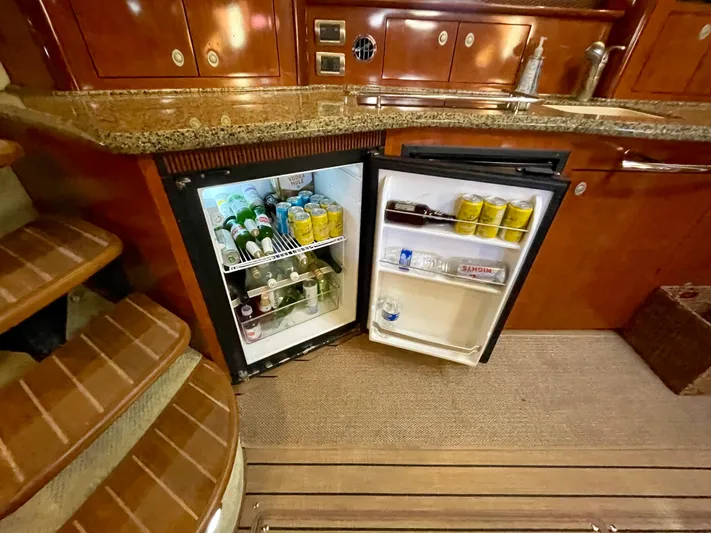Deja Blue Yacht Photos Pics Mini fridge in 2005 Sea Ray 390 Sundancer yacht galley, stocked with beverages.