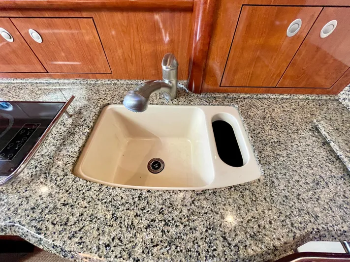Deja Blue Yacht Photos Pics Granite countertop with sink in 2005 Sea Ray 390 Sundancer yacht kitchen.