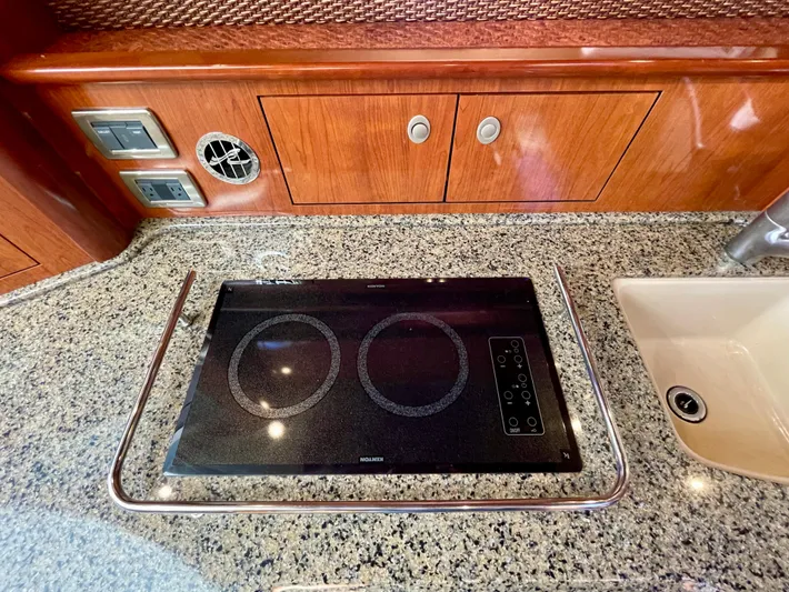 Deja Blue Yacht Photos Pics Granite countertop with stove and sink in 2005 Sea Ray 390 Sundancer yacht kitchen.
