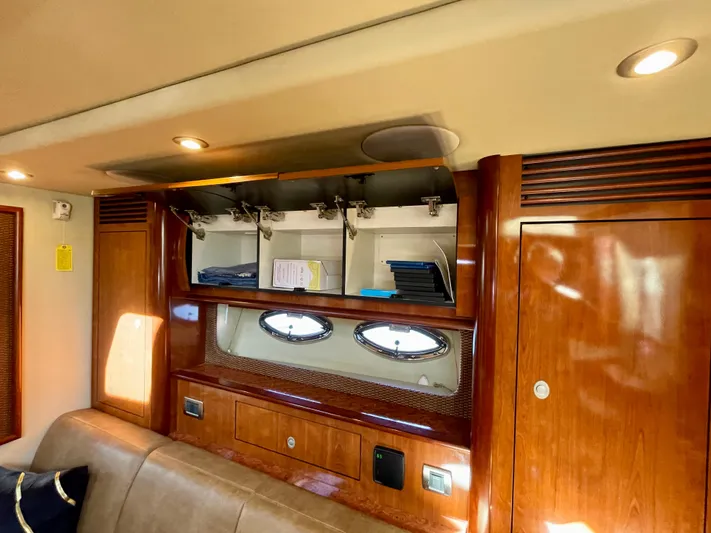 Deja Blue Yacht Photos Pics Interior of 2005 Sea Ray 390 Sundancer with wooden cabinets and porthole windows.