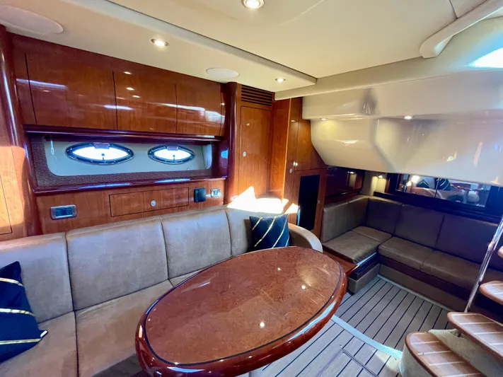 Deja Blue Yacht Photos Pics Luxurious interior of 2005 Sea Ray 390 Sundancer yacht with wood finishes and plush seating.