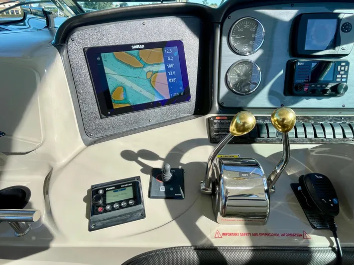 Deja Blue Yacht Photos Pics Control panel of 2005 Sea Ray 390 Sundancer with navigation display and throttle levers.