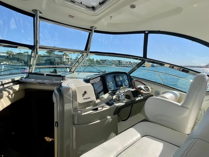 Deja Blue Yacht Photos Pics Interior view of 2005 Sea Ray 390 Sundancer yacht cockpit with waterfront background.