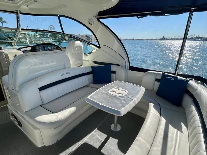 Deja Blue Yacht Photos Pics 2005 Sea Ray 390 Sundancer interior with white seating, table, and ocean view.