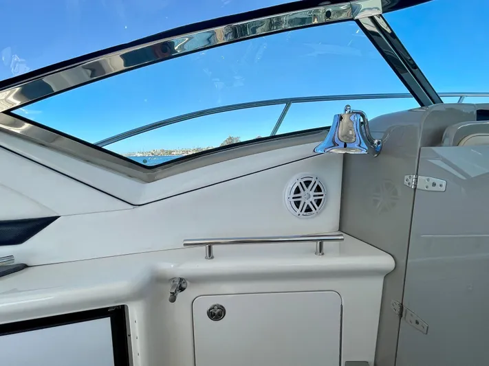 Deja Blue Yacht Photos Pics 2005 Sea Ray 390 Sundancer cockpit with bell and speaker, showcasing sleek design and functionality.