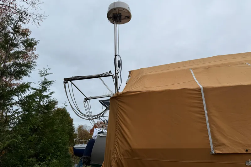Finisterre Yacht Photos Pics Catalina 36 MkII sailboat, 2006 model, covered with a tan tarp, surrounded by trees.