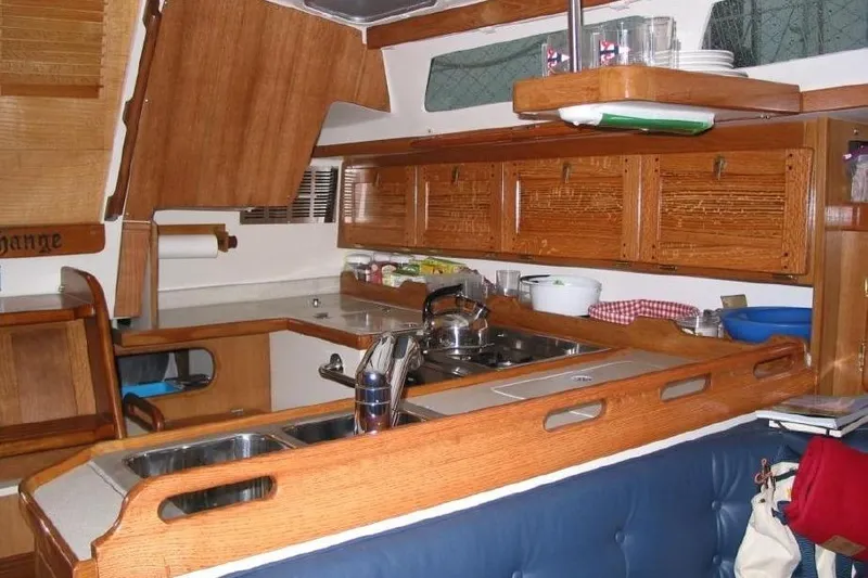Finisterre Yacht Photos Pics Interior of 2006 Catalina 36 MkII sailboat galley with wooden cabinetry and modern amenities.