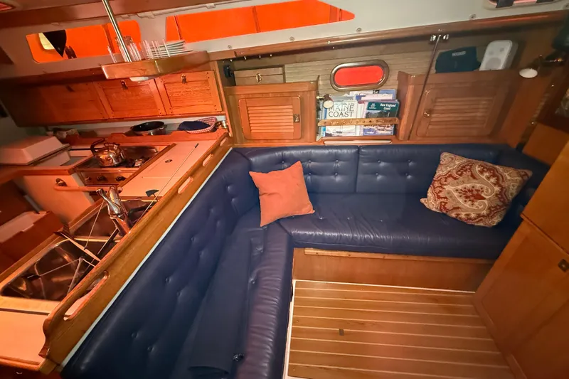 Finisterre Yacht Photos Pics Interior of 2006 Catalina 36 MkII sailboat with cozy seating and wooden cabinetry.