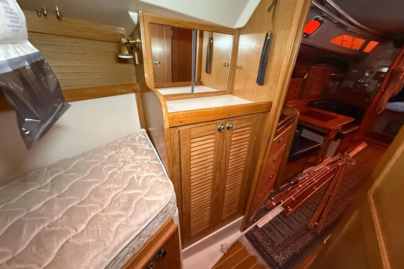 Finisterre Yacht Photos Pics Interior of 2006 Catalina 36 MkII sailboat with wooden cabinetry and cozy sleeping area.