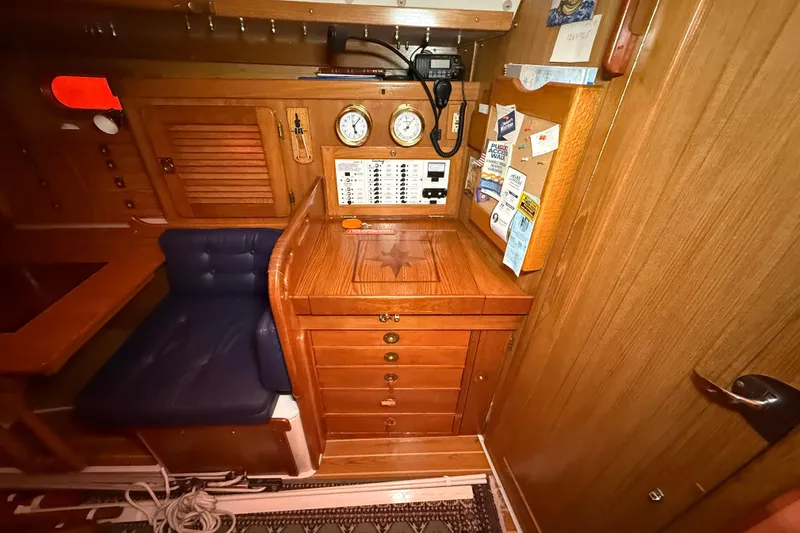 Finisterre Yacht Photos Pics Interior of 2006 Catalina 36 MkII sailboat with navigation station and wooden cabinetry.