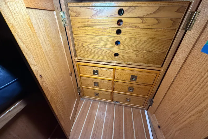 Finisterre Yacht Photos Pics Wooden cabinetry inside a 2006 Catalina 36 MkII sailboat, featuring multiple drawers.