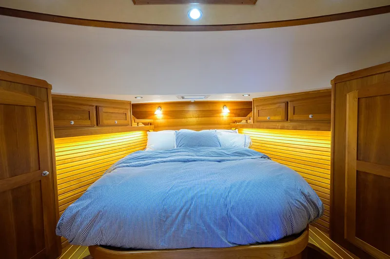 Vienna Yacht Photos Pics Luxurious cabin interior of 2018 Sabre 48 Salon Express with cozy bed and wooden accents.